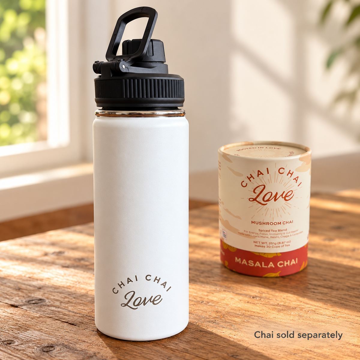 White insulated chai bottle with Chai Chai Love Masala Chai tube in the background, labeled Chai sold separately