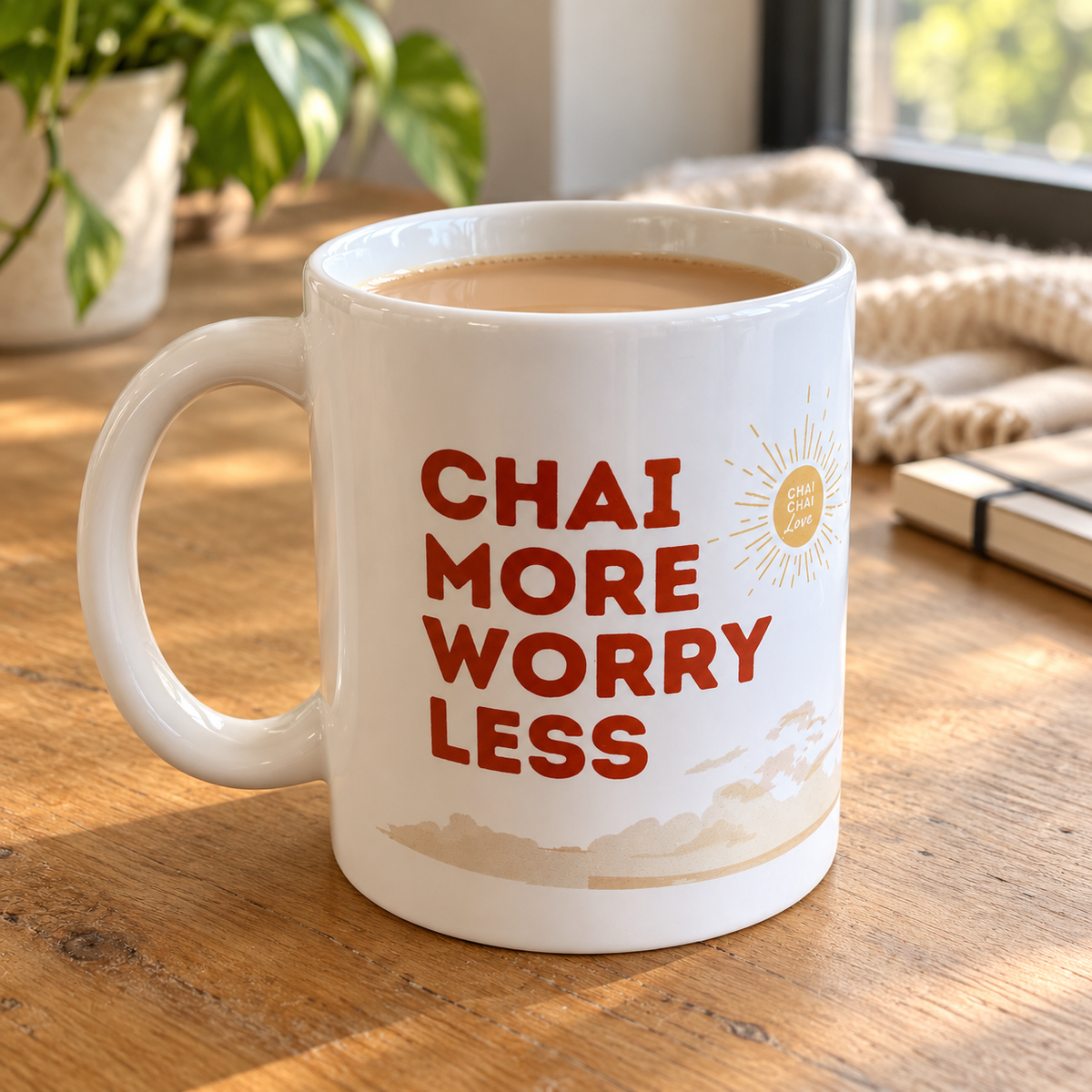 Chai More, Worry Less mug filled with chai beside a notebook by a window; chai sold separately